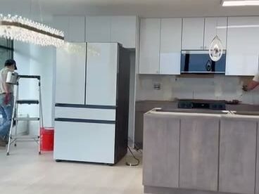 Renovated condo kitchen with island and pendant lights
